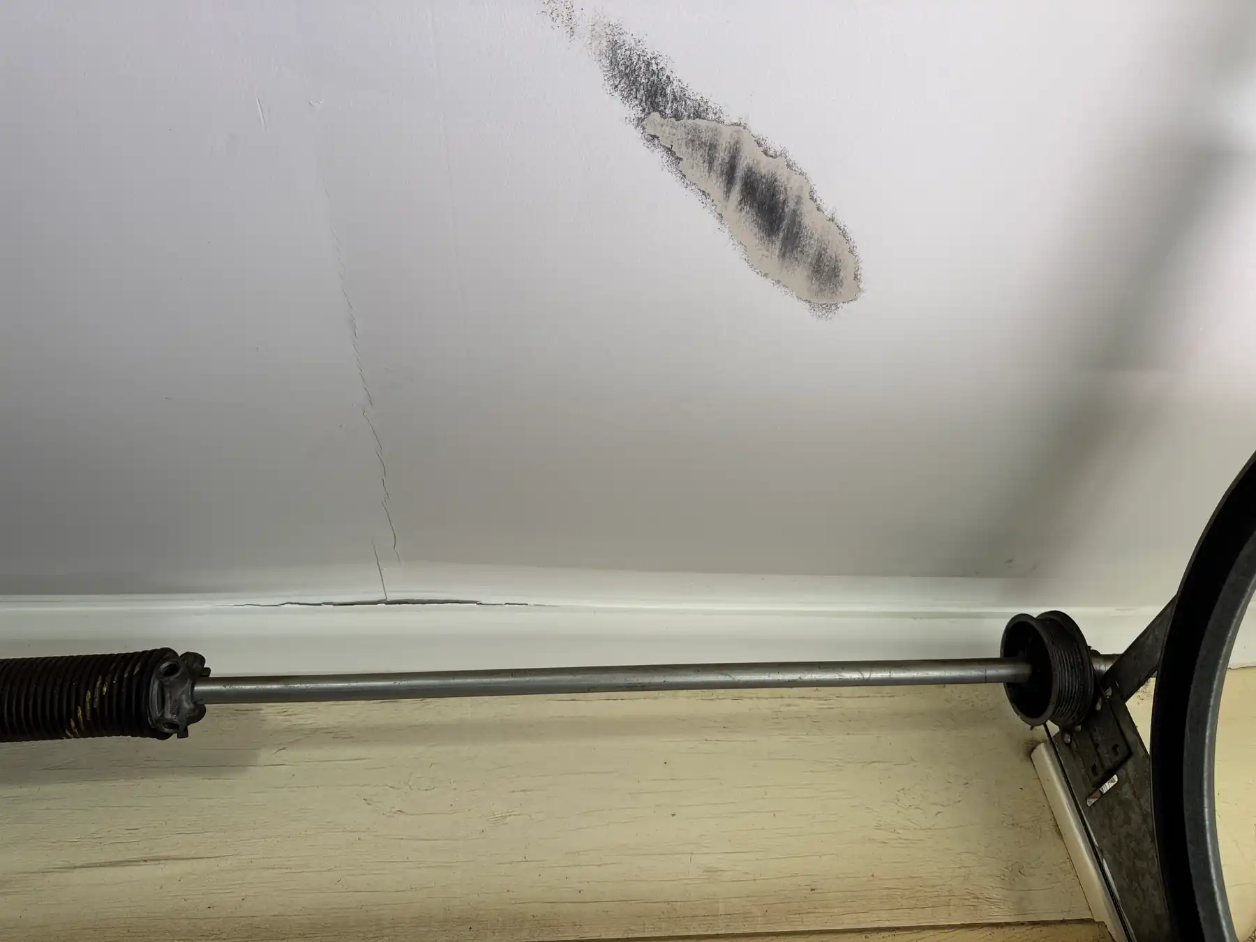 Dark staining on a garage ceiling beside the door track.